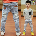 Young boy wearing Ancient Energy boys' spring and autumn pants, casual style, comfortable fit, outdoor setting
