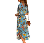 Woman wearing a Mandotos International chic V-neck high-waist blue floral maxi dress.