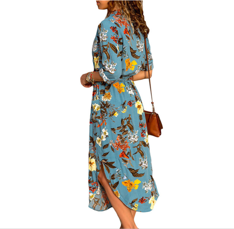 Woman wearing a Mandotos International chic V-neck high-waist blue floral maxi dress.