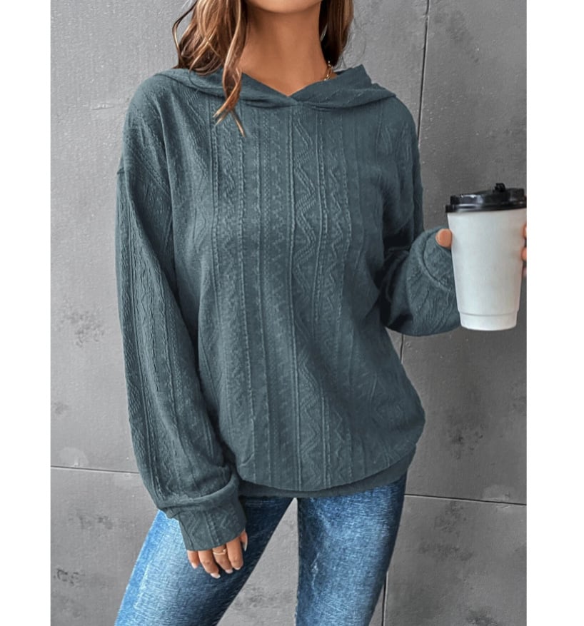 Woman wearing a Mandotos International autumn casual solid green textured hoodie and blue jeans.