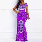 Woman wearing a Mandotos International Euro-American chic purple print maxi dress.