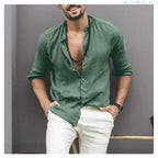Man wearing a Mandotos International green classic buttoned collar shirt and white trousers.