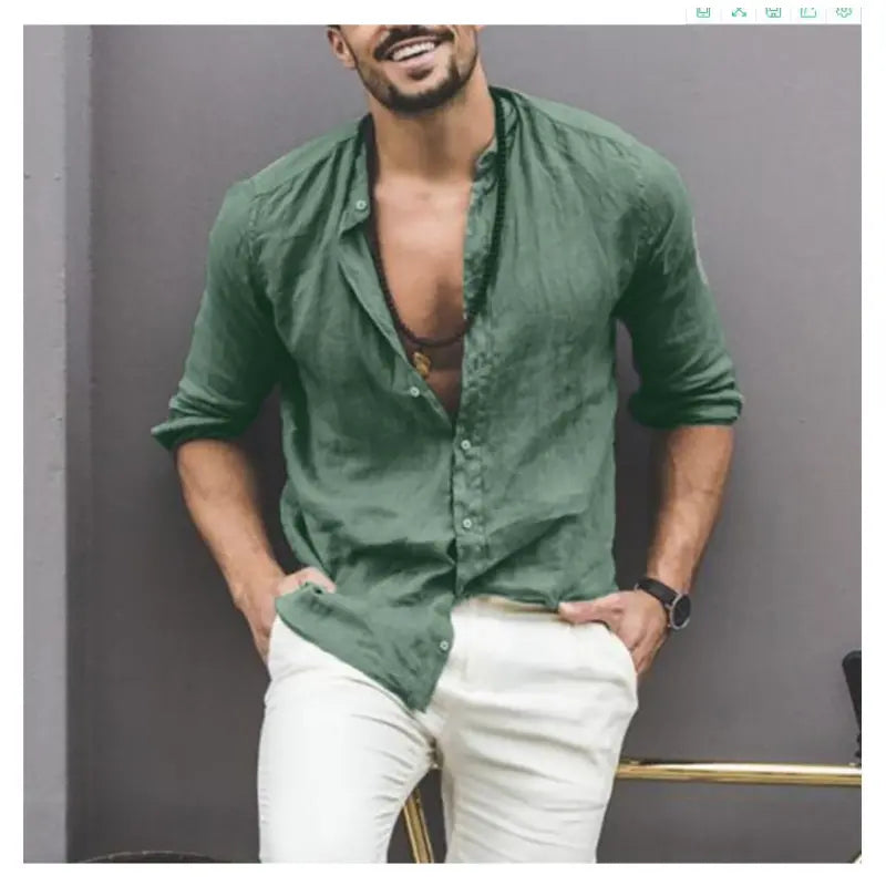 Man wearing a Mandotos International green classic buttoned collar shirt and white trousers.