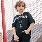 Children's printed T-shirt by Ancient Energy featuring colorful cartoon designs on soft fabric.