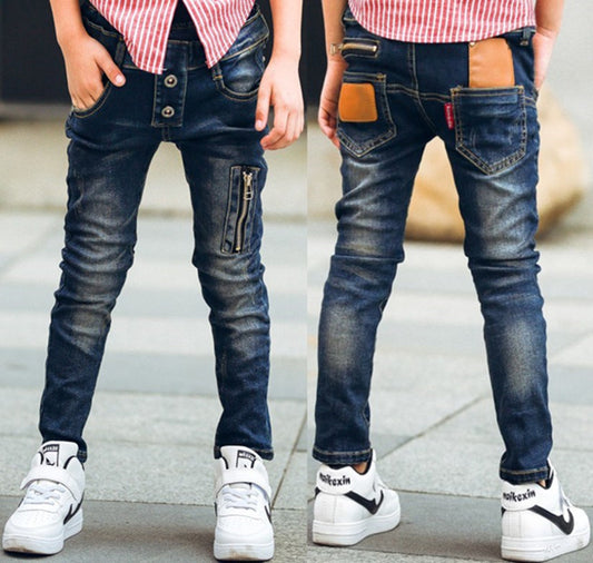 Boy wearing Ancient Energy stretch denim pants, casual boys' jeans with a classic fit and blue denim fabric.