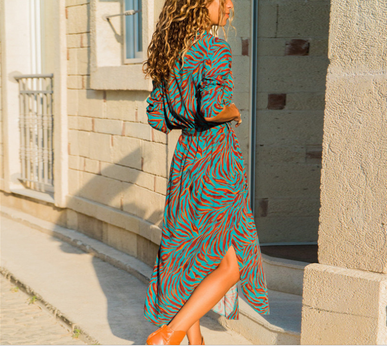 Woman wearing a chic V-neck high-waist printed dress with a teal and orange pattern.