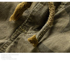 Close-up of camouflage pattern fabric with drawstring detail on men's outdoor summer shorts.
