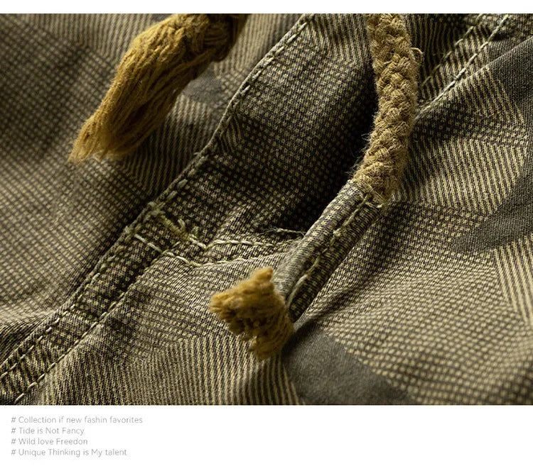 Close-up of camouflage pattern fabric with drawstring detail on men's outdoor summer shorts.