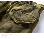 Close-up of men's camouflage pattern outdoor cargo shorts with a utility pocket.