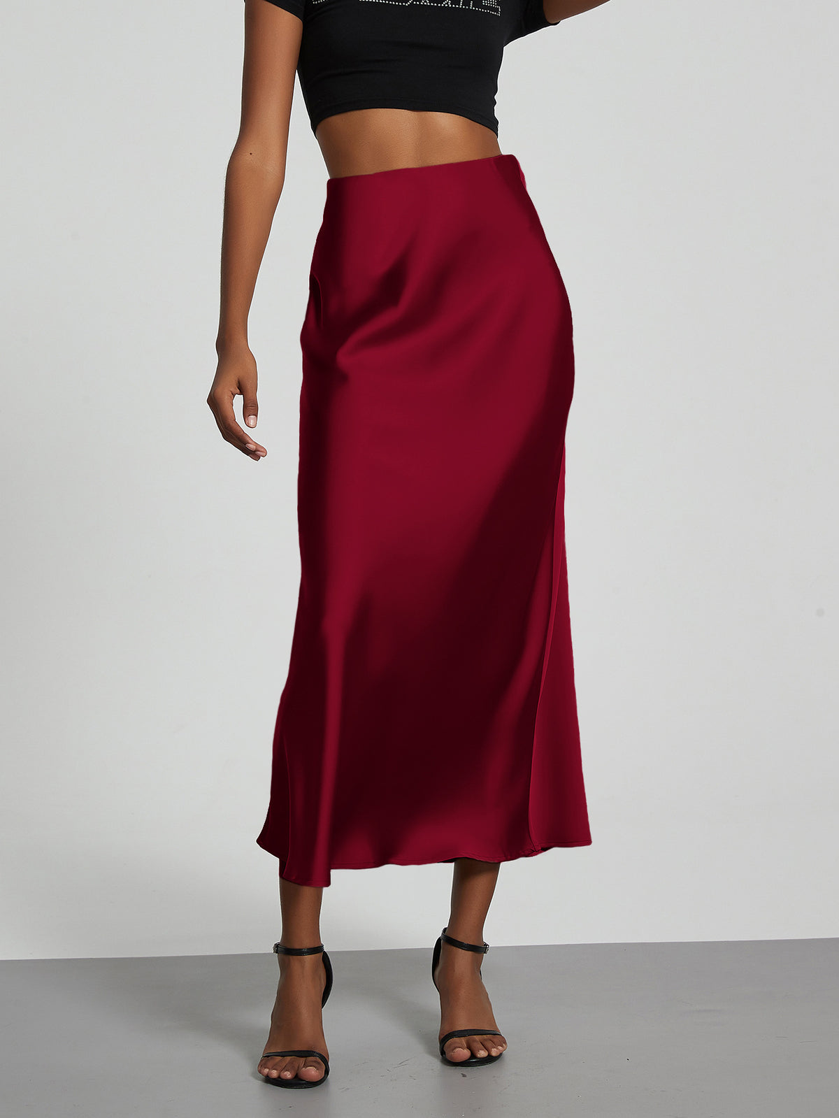 Elegant burgundy satin midi skirt with a slim, flowy silhouette by Mandotos International