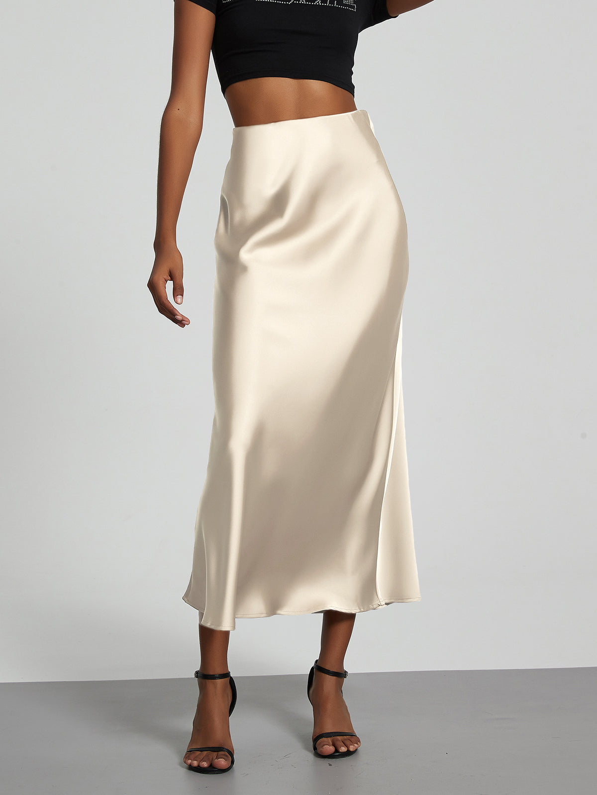 Elegant cream satin midi skirt with a slim, flowy silhouette for women.