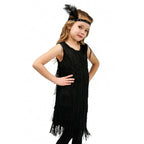 Girl in black sequin fringe flapper dress and feather headband for carnival or Latin dance.
