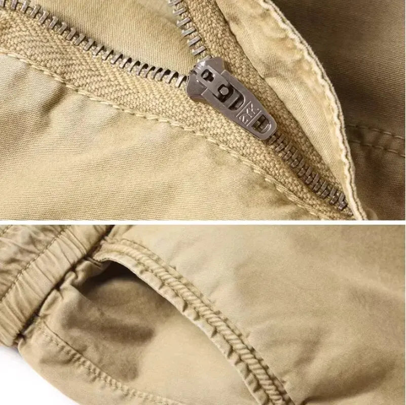 Close-up of the metal zipper and pocket detail on khaki cotton cargo pants.