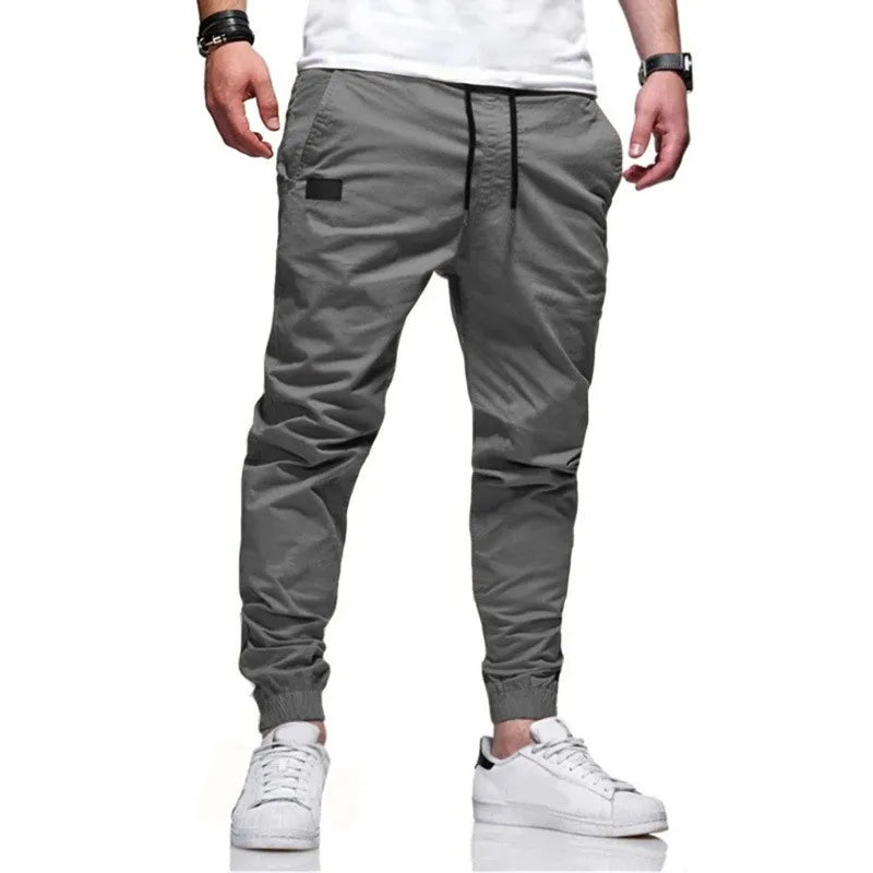 Men's casual grey jogger cargo pants with drawstring waist and multi-pocket design.
