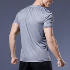 Man wearing a grey Mandotos International quick dry compression sport t-shirt for fitness.