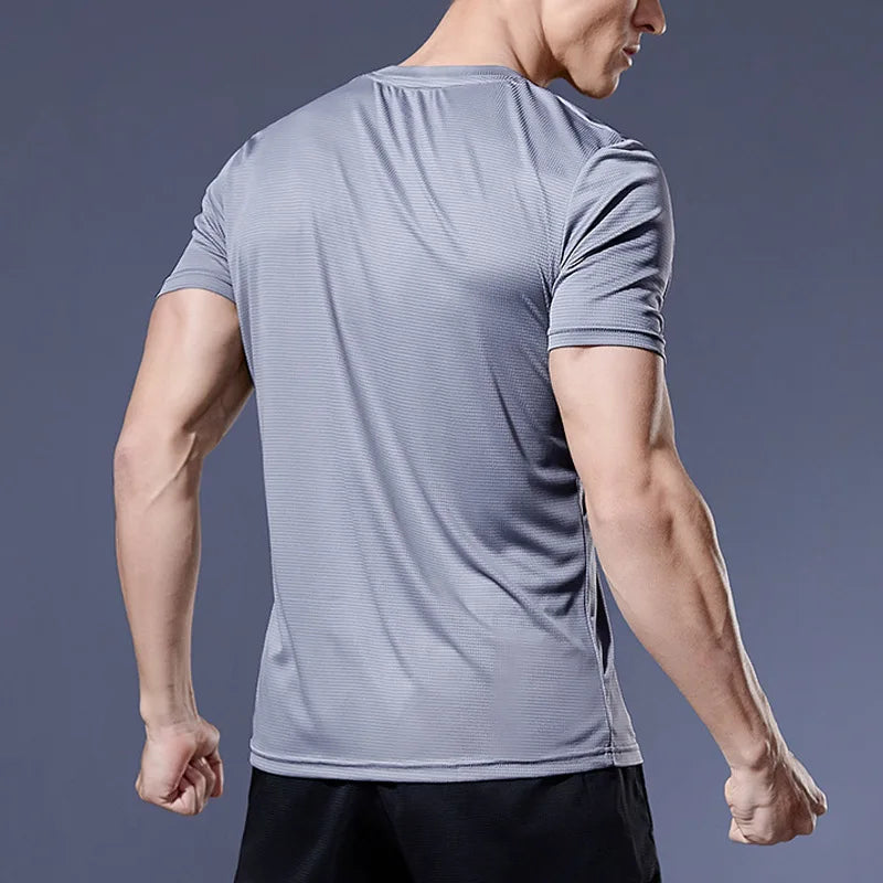 Man wearing a grey Mandotos International quick dry compression sport t-shirt for fitness.
