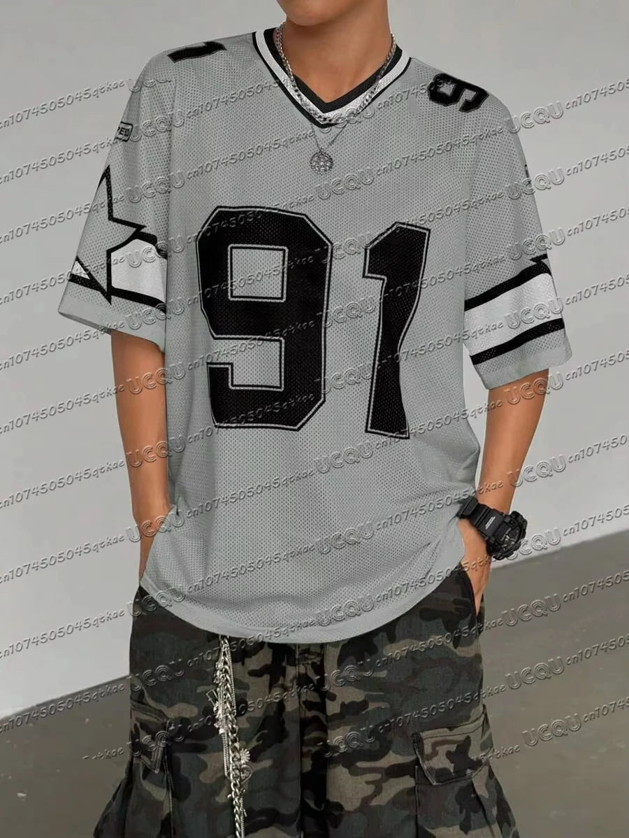 Woman wearing a grey Mandotos International loose short sleeve t-shirt with black number 91 print.