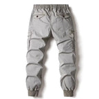Grey cotton cargo pants for men featuring tactical military pockets and elastic jogger cuffs.
