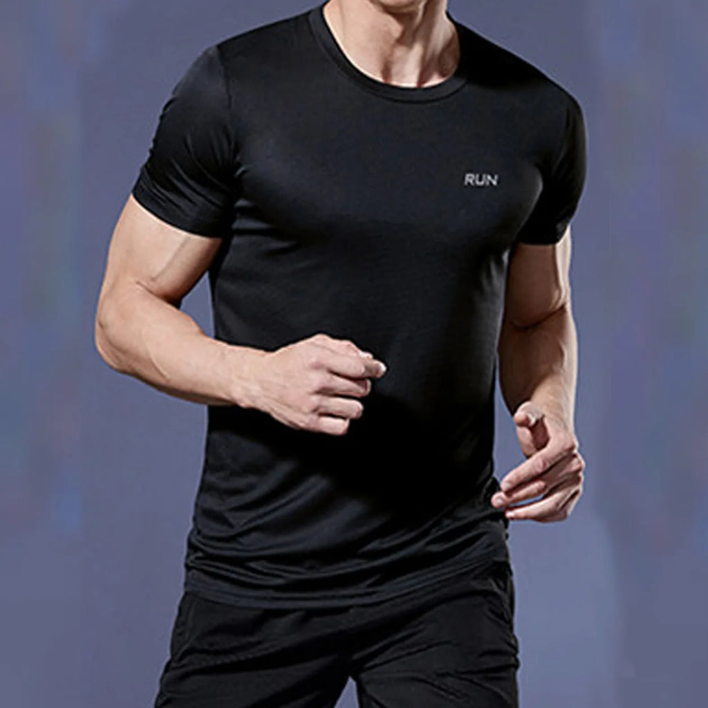 Man wearing a black Mandotos International quick dry compression running shirt for fitness.