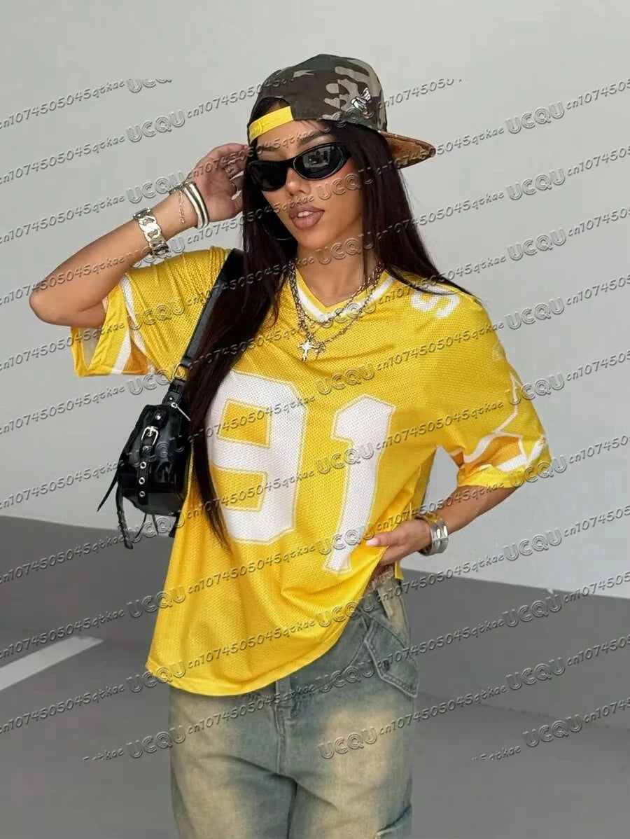 Woman wearing a yellow digital print casual summer T-shirt and sunglasses.