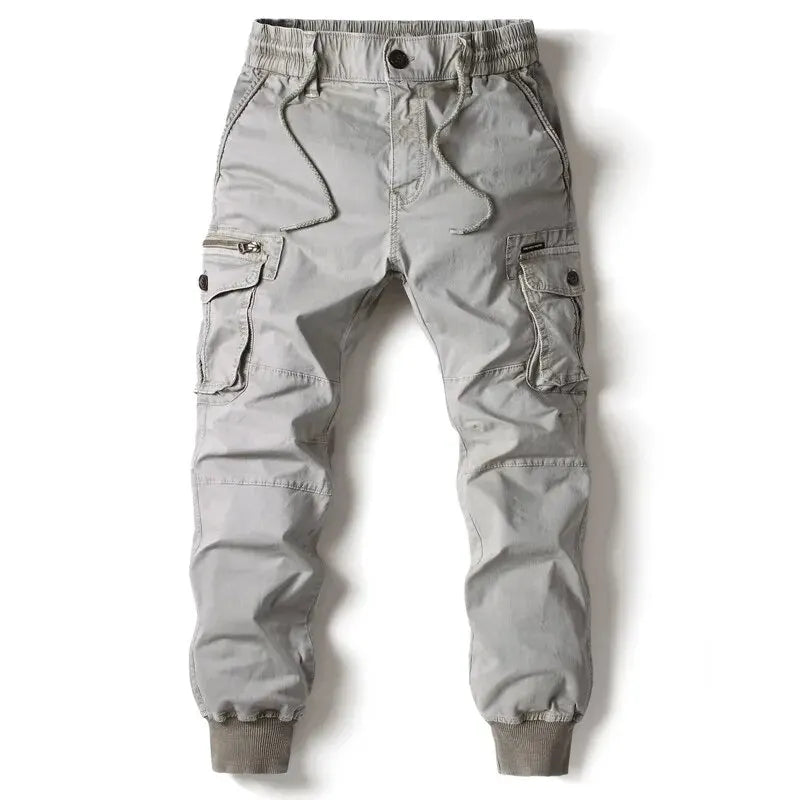Men's grey cotton cargo pants with tactical pockets and drawstring waist.