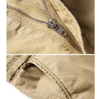 Close-up of the durable metal zipper and stitching on khaki cotton cargo pants.