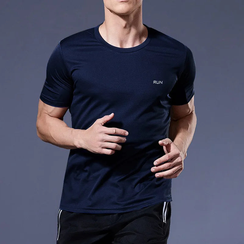 Man wearing a navy blue Mandotos International quick-dry compression running t-shirt