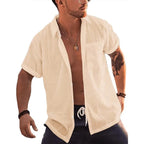 Man wearing a cream linen cotton short sleeve button up beach shirt with pocket.
