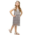 Girl in silver sequin fringe flapper dress with feather headband for carnival or Latin dance.