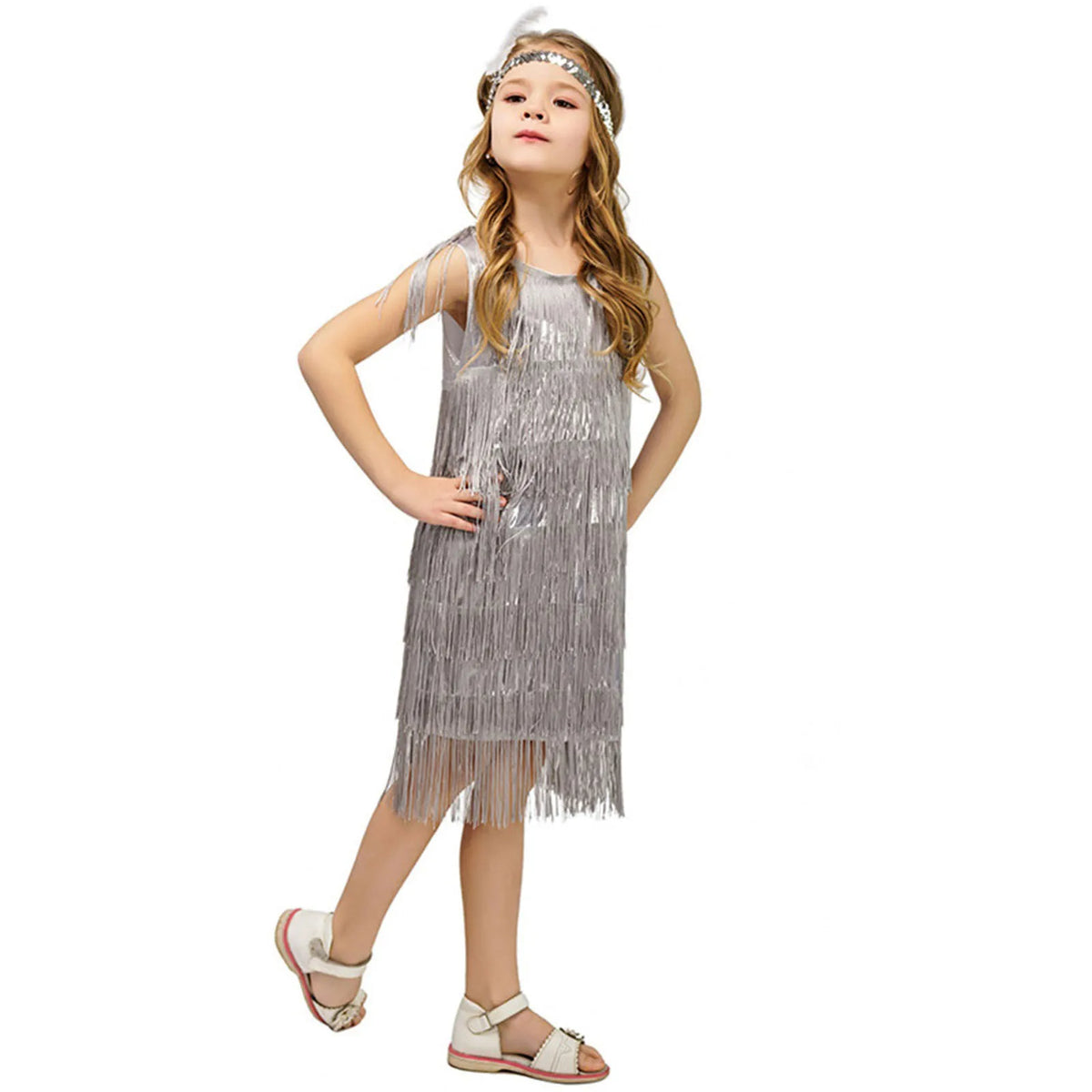 Girl in silver sequin fringe flapper dress with feather headband for carnival or Latin dance.
