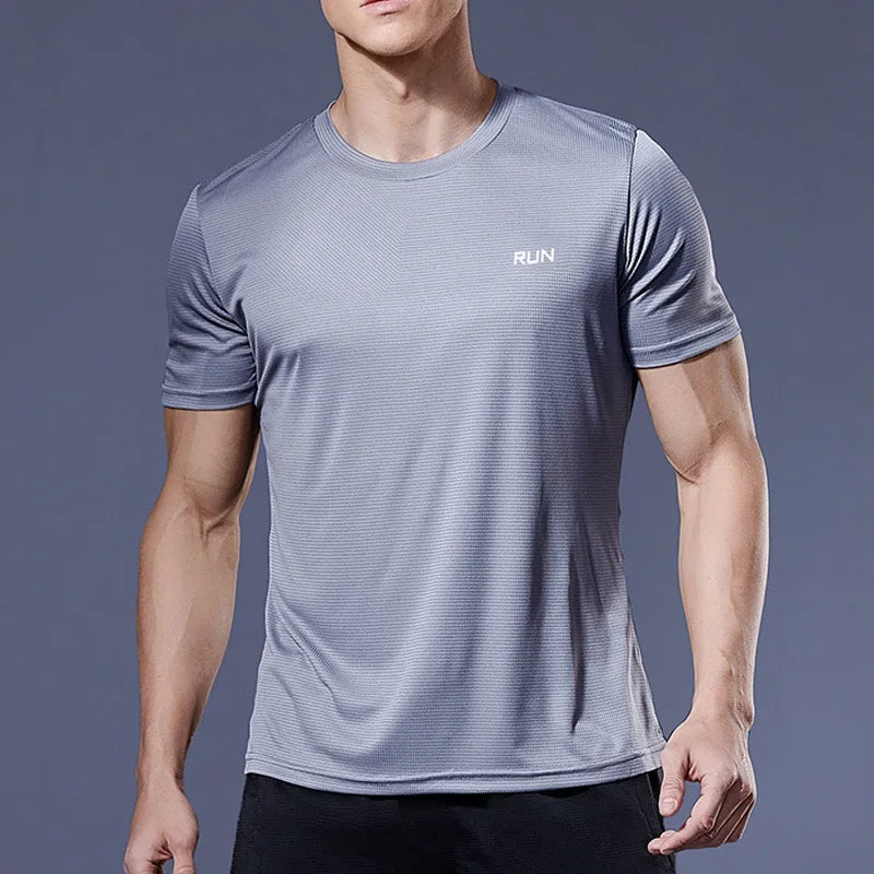 Man wearing a grey Mandotos International quick dry running t-shirt for fitness and gym.