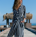 Woman wearing a Mandotos International chic V-neck high-waist printed striped jumpsuit.