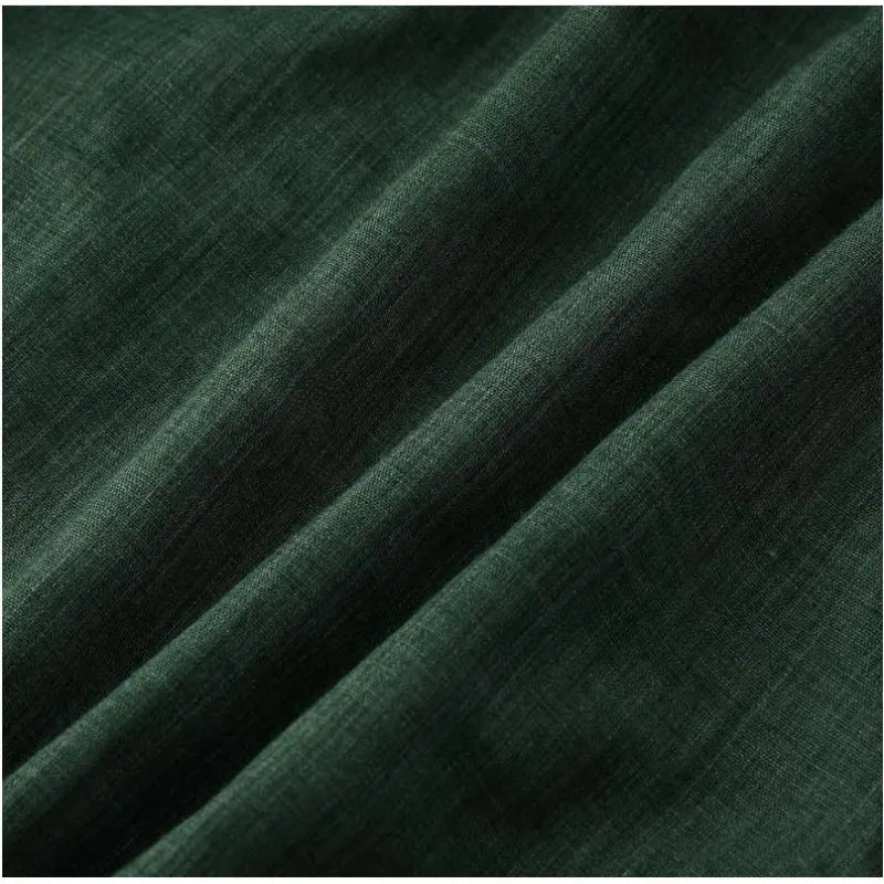 Close-up detail of dark green fabric from a Mandotos International men's buttoned collar shirt