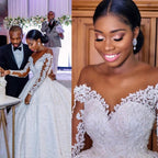 Elegant custom wedding gown by Ancient Energy featuring intricate lace details and a flowing train for bridal elegance.