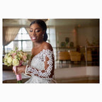 Elegant custom wedding gown by Ancient Energy featuring intricate lace details and a flowing train for bridal elegance.