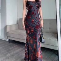 Ancient Energy black flocked strappy maxi dress featuring a fitted bodice and flowing skirt, ideal for elegant occasions.