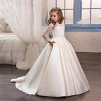 Little girl wearing a champagne long sleeve dress by Ancient Energy, soft fabric and elegant style for special occasions.
