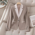 Elegant formal blazer by Ancient Energy featuring contrasting color buttons and a tailored fit for professional or dressy occasions.