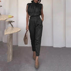 Ancient Energy shoulder slimming waist belt paired with a stylish blouse and pants, showcasing a modern fashion look.