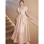 Women’s champagne evening dress by Ancient Energy featuring elegant design and flowing fabric for formal occasions.