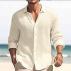 Man wearing a Mandotos International plus size men's casual white lapel shirt on a beach.