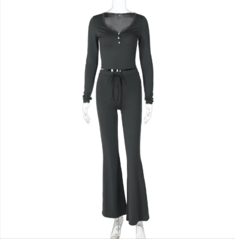 Chic black milk silk two-piece outfit featuring a long-sleeve top and flared trousers.