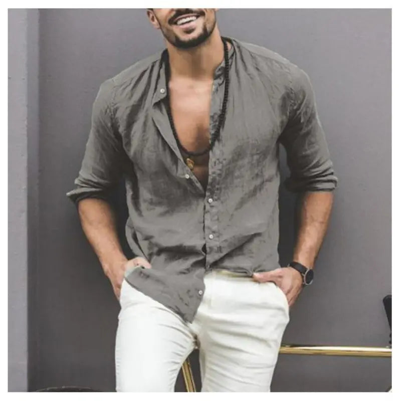 Man wearing a Mandotos International classic buttoned collar olive green shirt and white trousers.