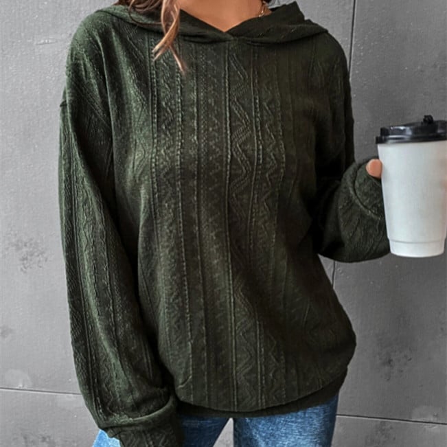 Woman wearing a Mandotos International dark green cable knit autumn casual hoodie