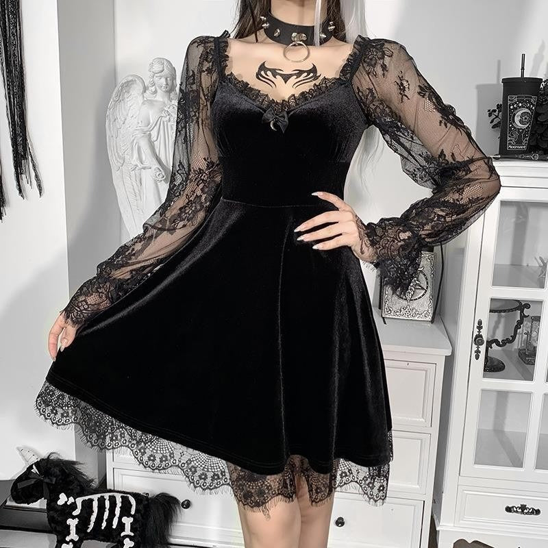 Woman wearing a Mandotos International black velvet lace hip-hop dress with long sheer sleeves.