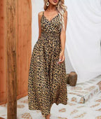 A woman wearing a chic leopard print midi suspender dress by Mandotos International.