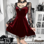 Woman wearing a Mandotos International red velvet gothic dress with black lace sleeves.