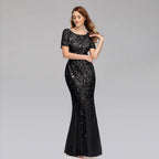 Elegant black evening dress by MANDOTOS featuring a fitted bodice and flowing skirt, perfect for formal occasions.