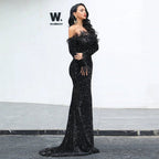Elegant black evening dress by MANDOTOS featuring a fitted bodice and flowing skirt, perfect for formal occasions.