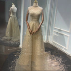 Elegant golden neck hanging light luxury evening dress by MANDOTOS, featuring a sophisticated toast-colored design and intricate details.